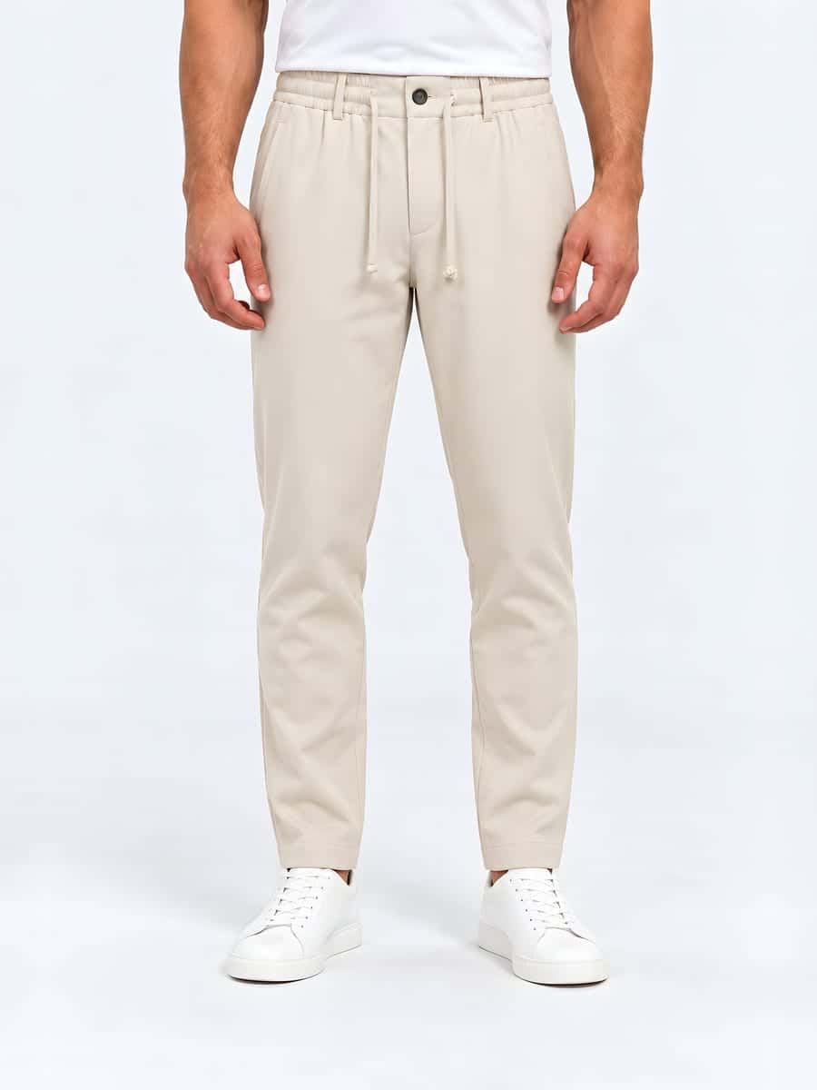 Tapered drawstring trousers in beige, front view