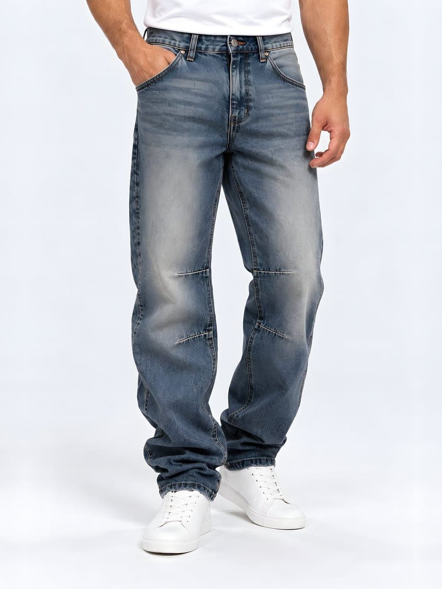 Baggy jeans with panel seams in blue grey, washed, worn with a hand in the pocket