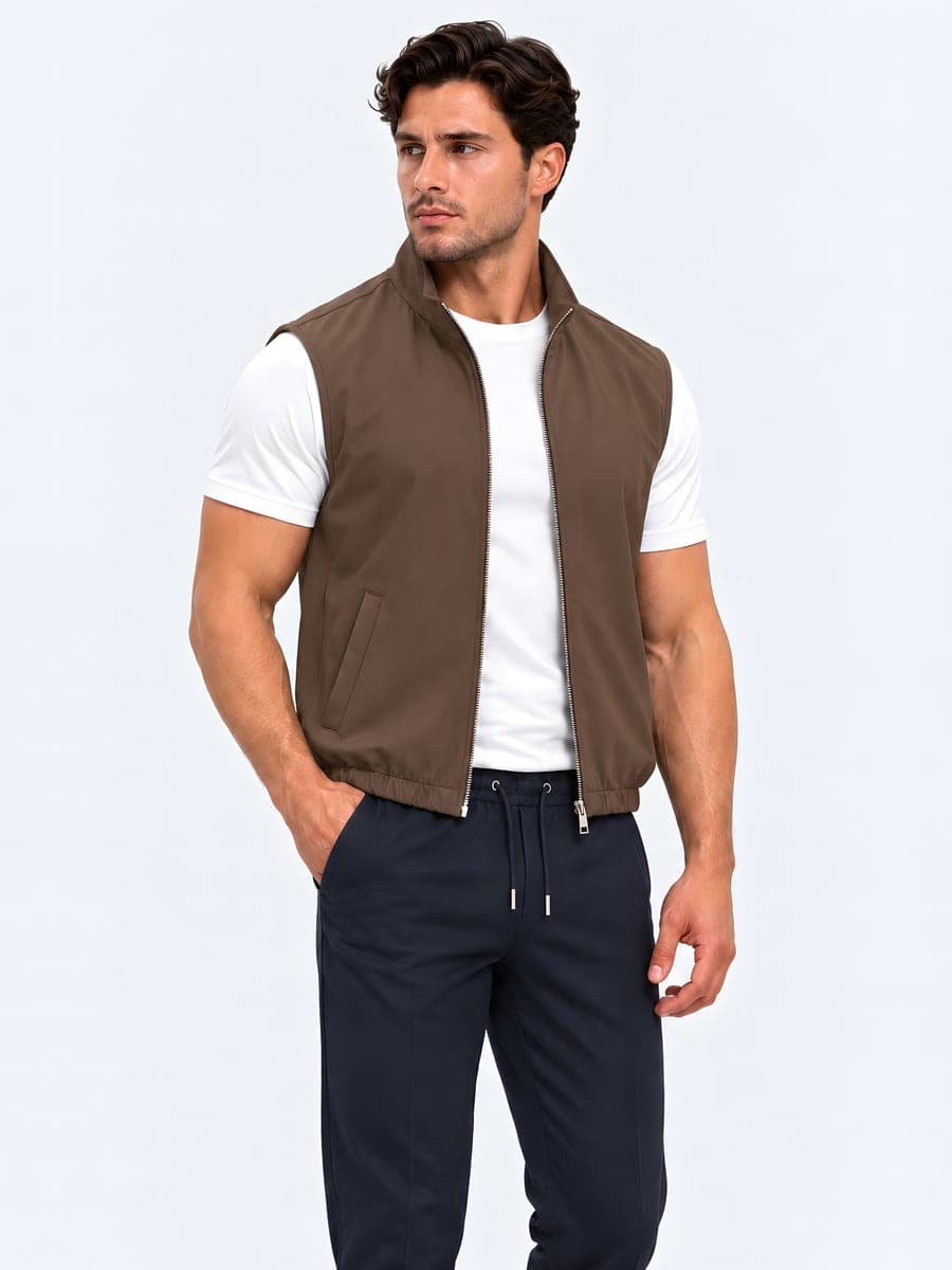 Polyester bodywarmer with a two-way zip in brown, worn with a hand in the pocket