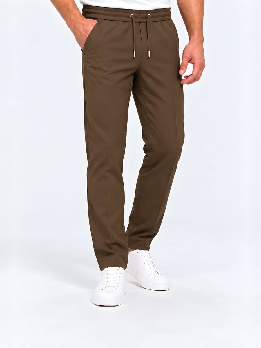 Polyester straight leg drawstring trousers in brown, worn with a hand in the pocket