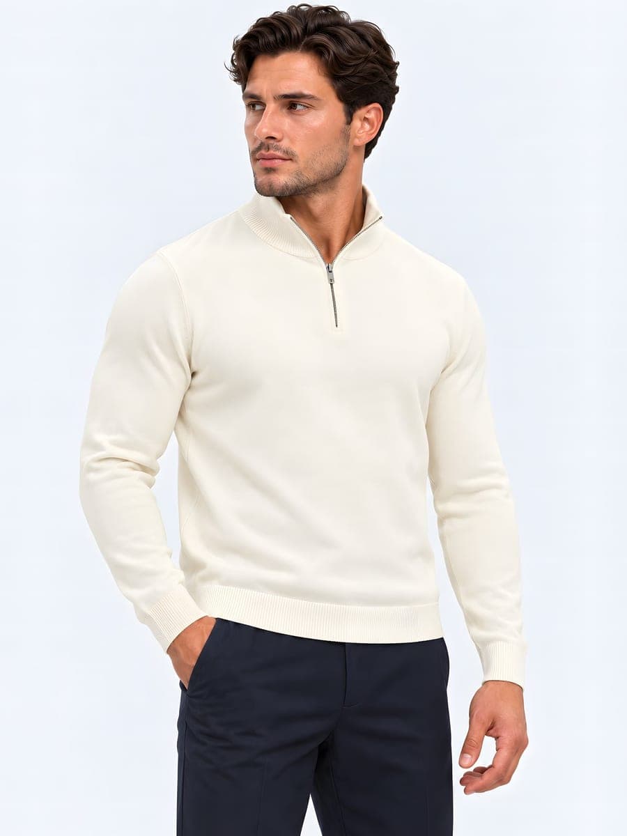 Knitted half zip sweater in cream, worn with a hand in the pocket