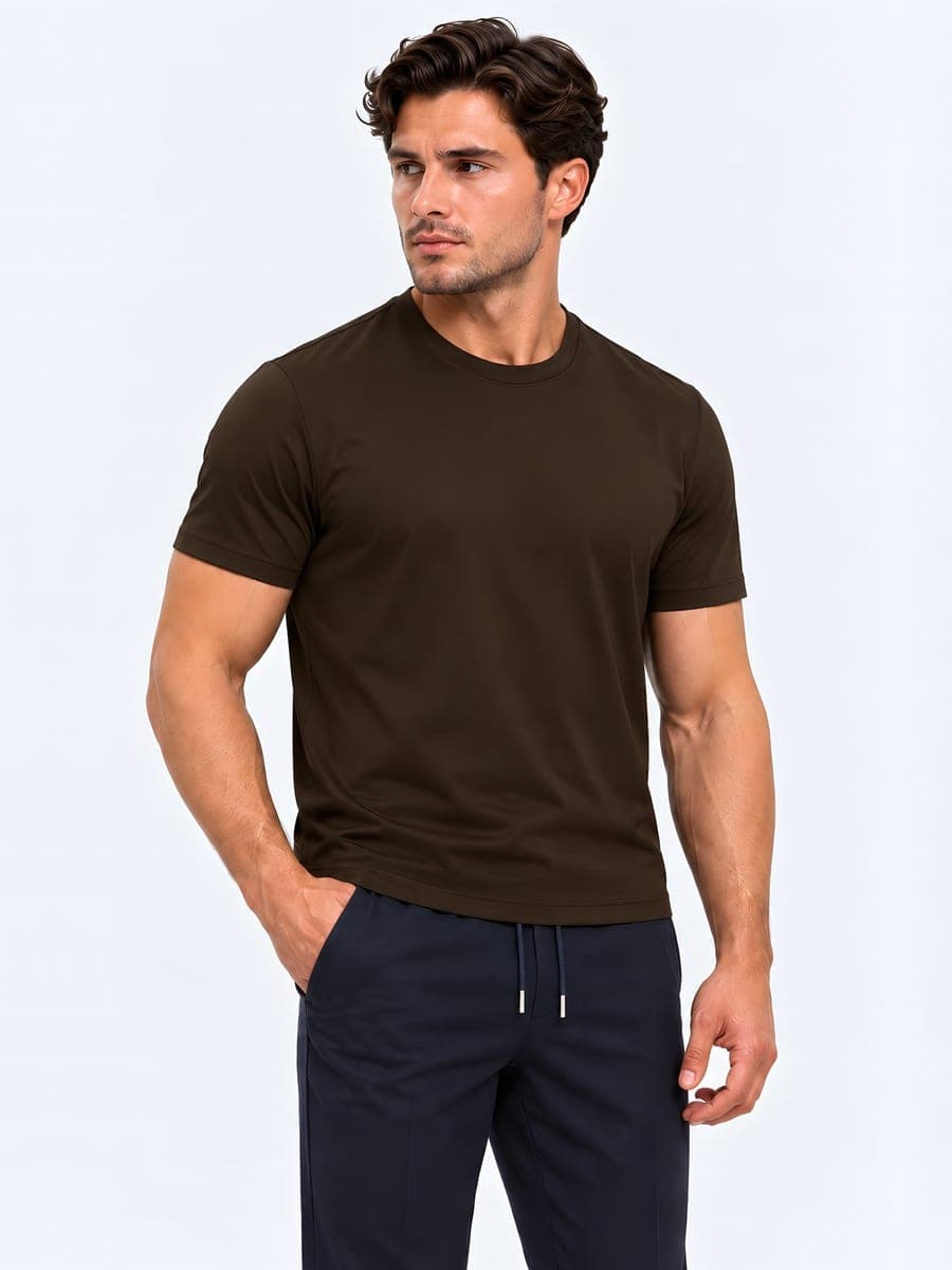 Cotton T-shirt with a subtle sheen in dark brown, worn with a hand in the pocket