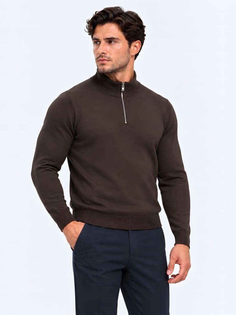Knitted half zip sweater in dark brown, worn with a hand in the pocket