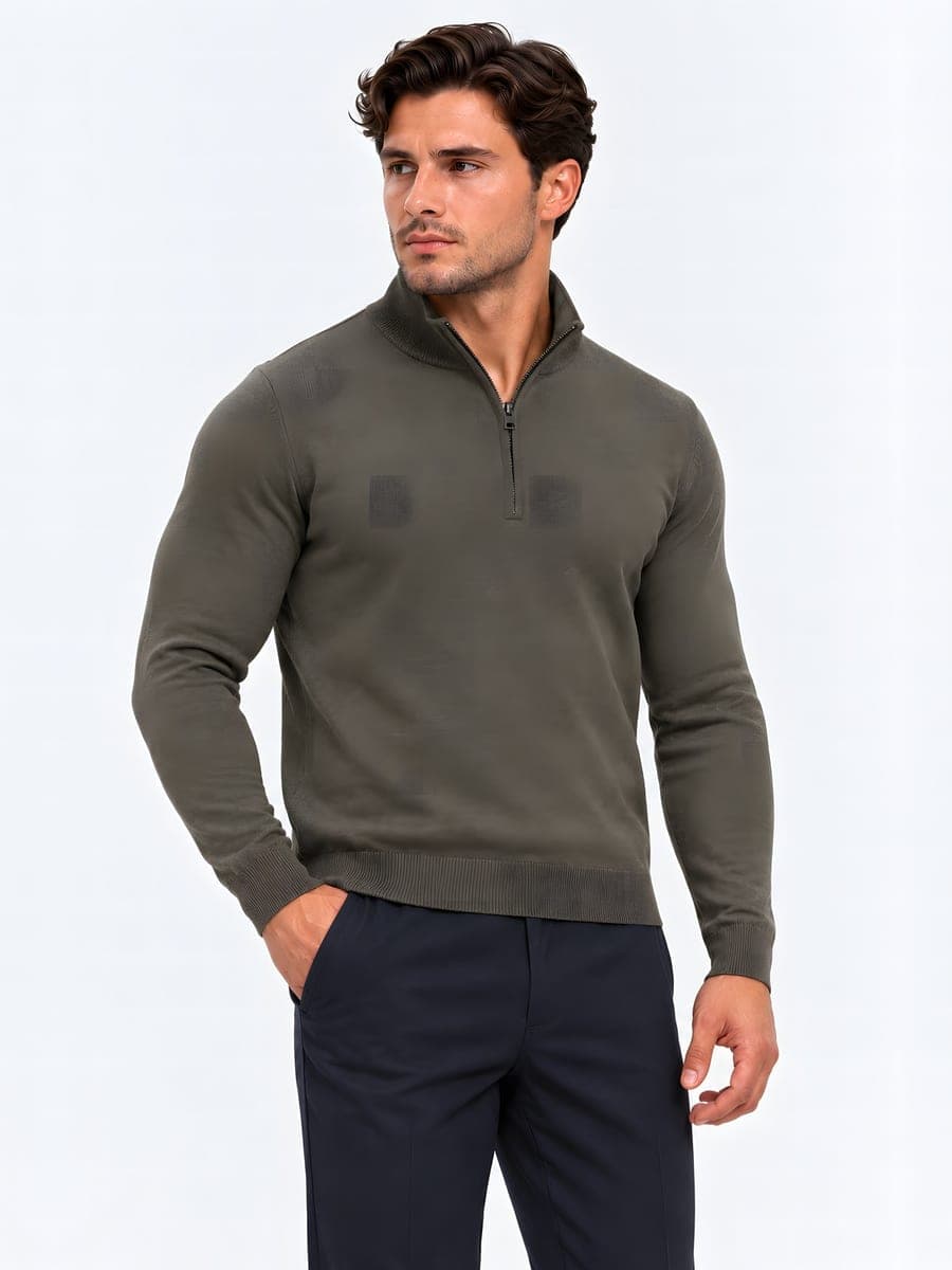 Fitted knit with a short zip in green, worn with a hand in the pocket
