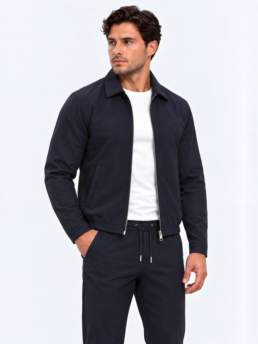 Lightly lined jacket with a lapel collar in navy, worn with a hand in the pocket