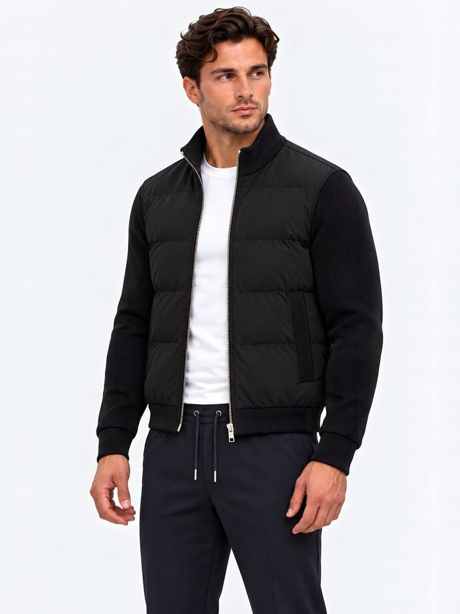 Padded jacket with knitted sleeves in black, angled front view