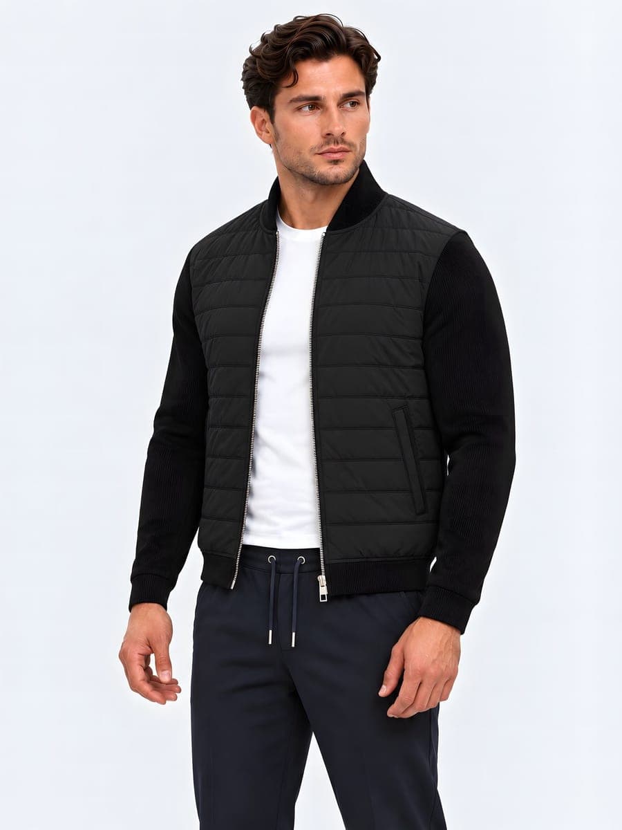 Jacket with a quilted body and plain sleeves in black, angled front view