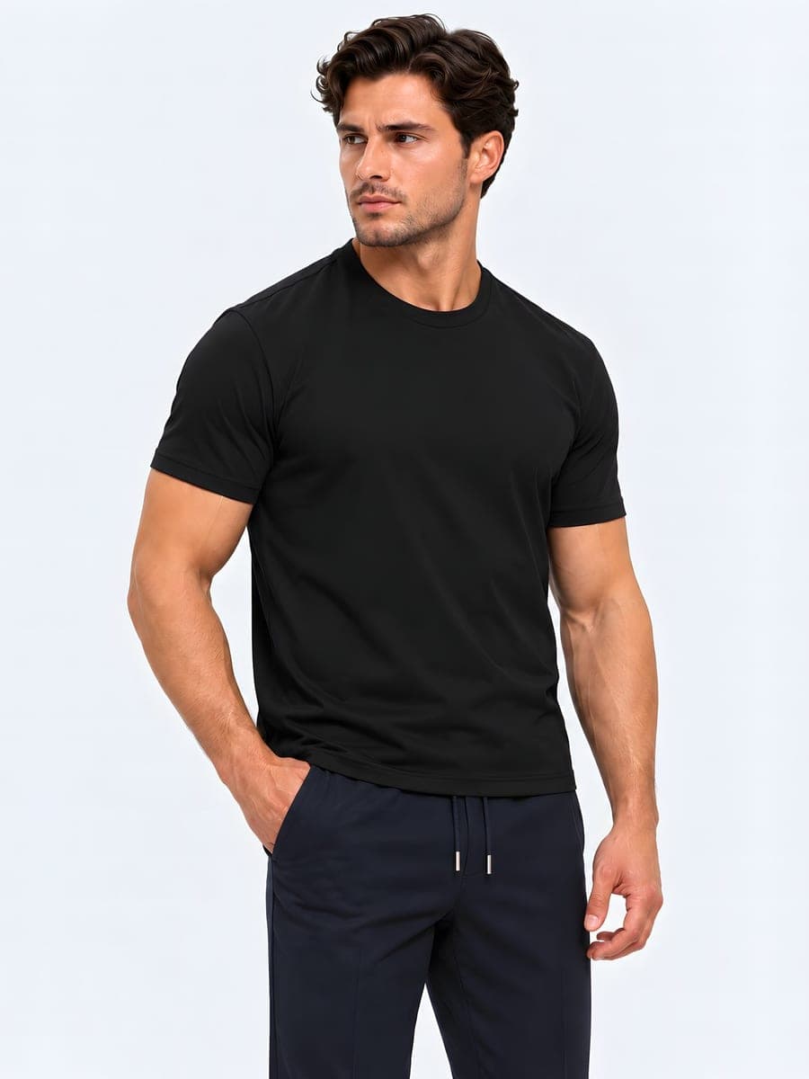 Cotton T-shirt with a subtle sheen in black, worn with a hand in the pocket