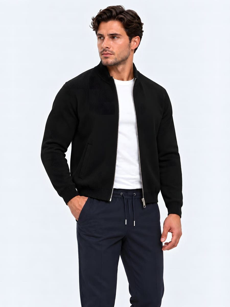 Heavy cotton zip cardigan in black, worn with a hand in the pocket