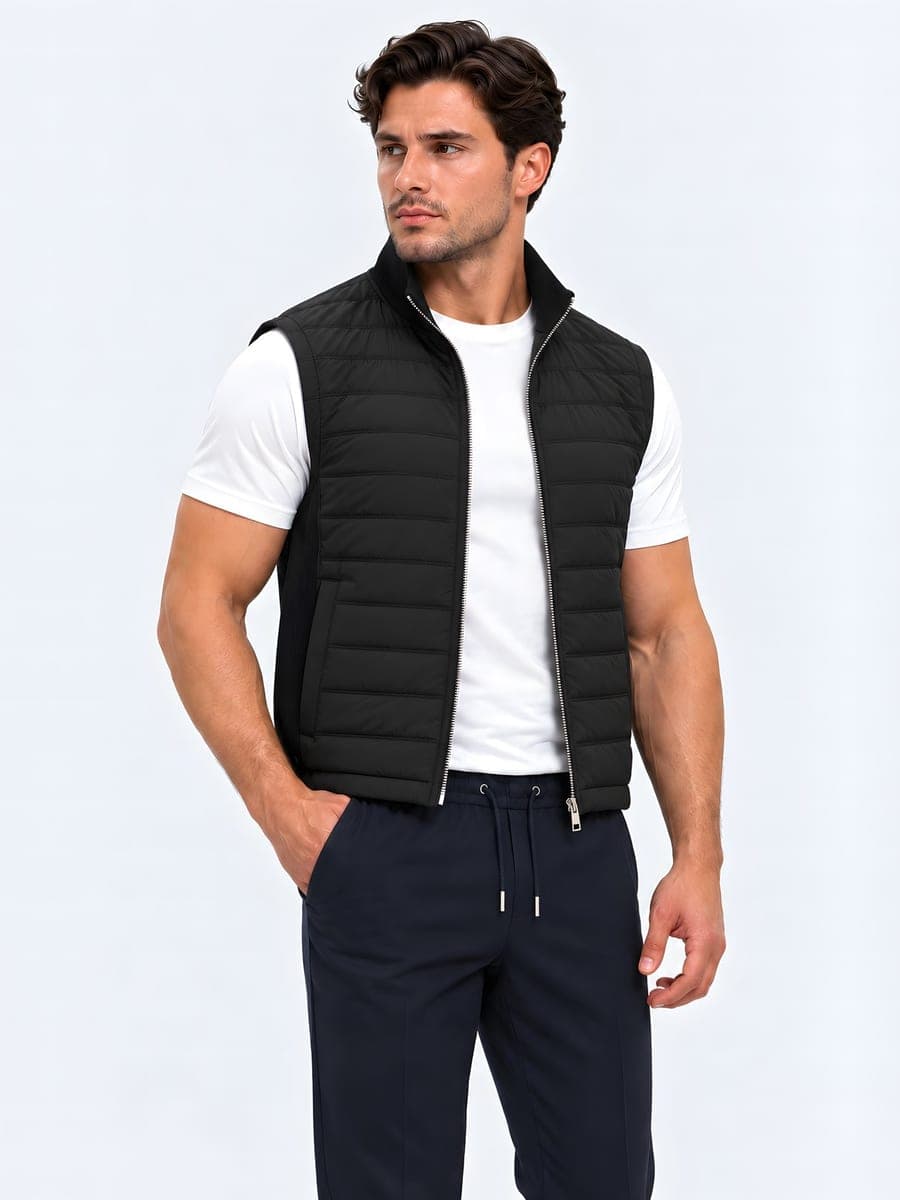 Quilted bodywarmer in black, worn with a hand in the pocket