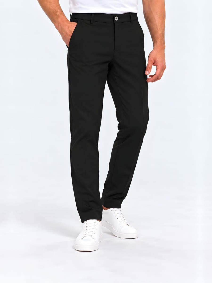 Smooth straight leg trousers in black, worn with a hand in the pocket