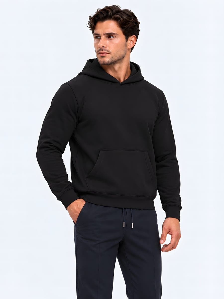 Heavyweight hoodie, regular fit in black, worn with a hand in the pocket