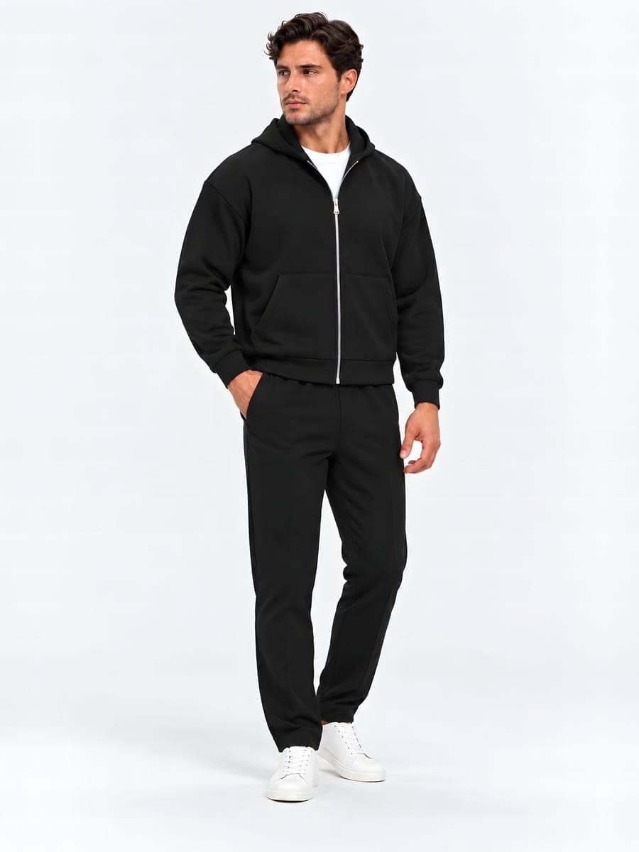 Oversized zip hoodie set in black, worn with a hand in the pocket