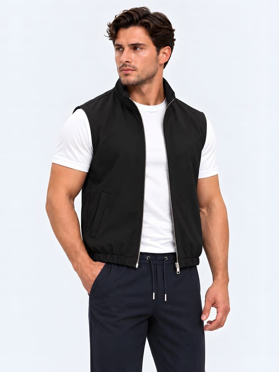 Polyester bodywarmer with a two-way zip in black, worn with a hand in the pocket