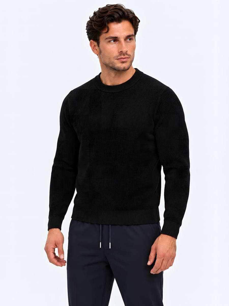 Waffle knit sweater in black, angled front view