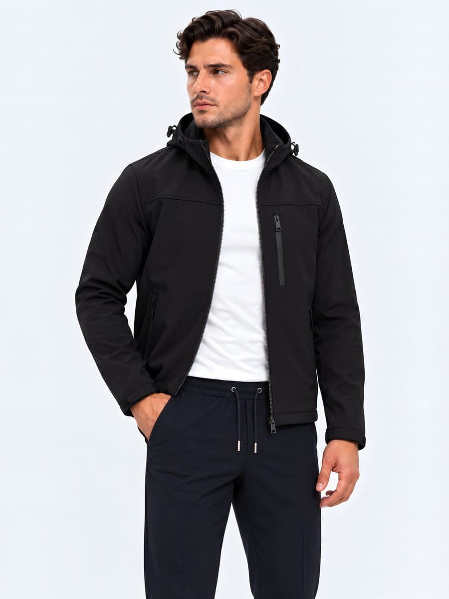 Waterproof hooded jacket in black, worn with a hand in the pocket
