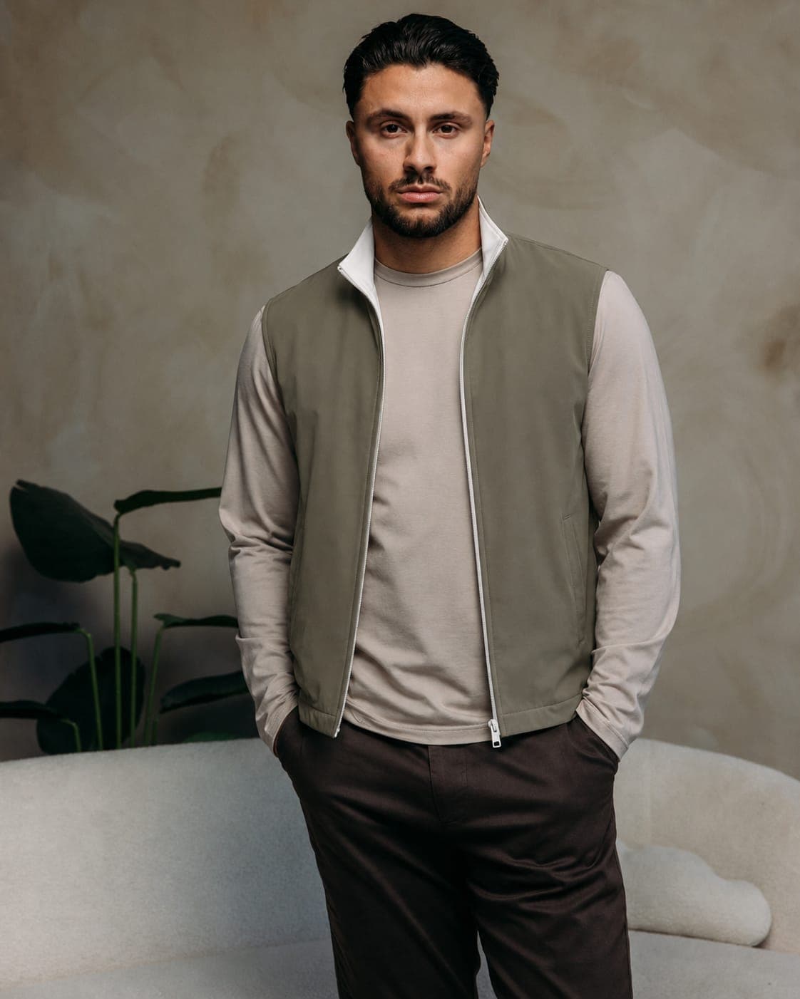 Olive green bodywarmer vest with a cream t-shirt