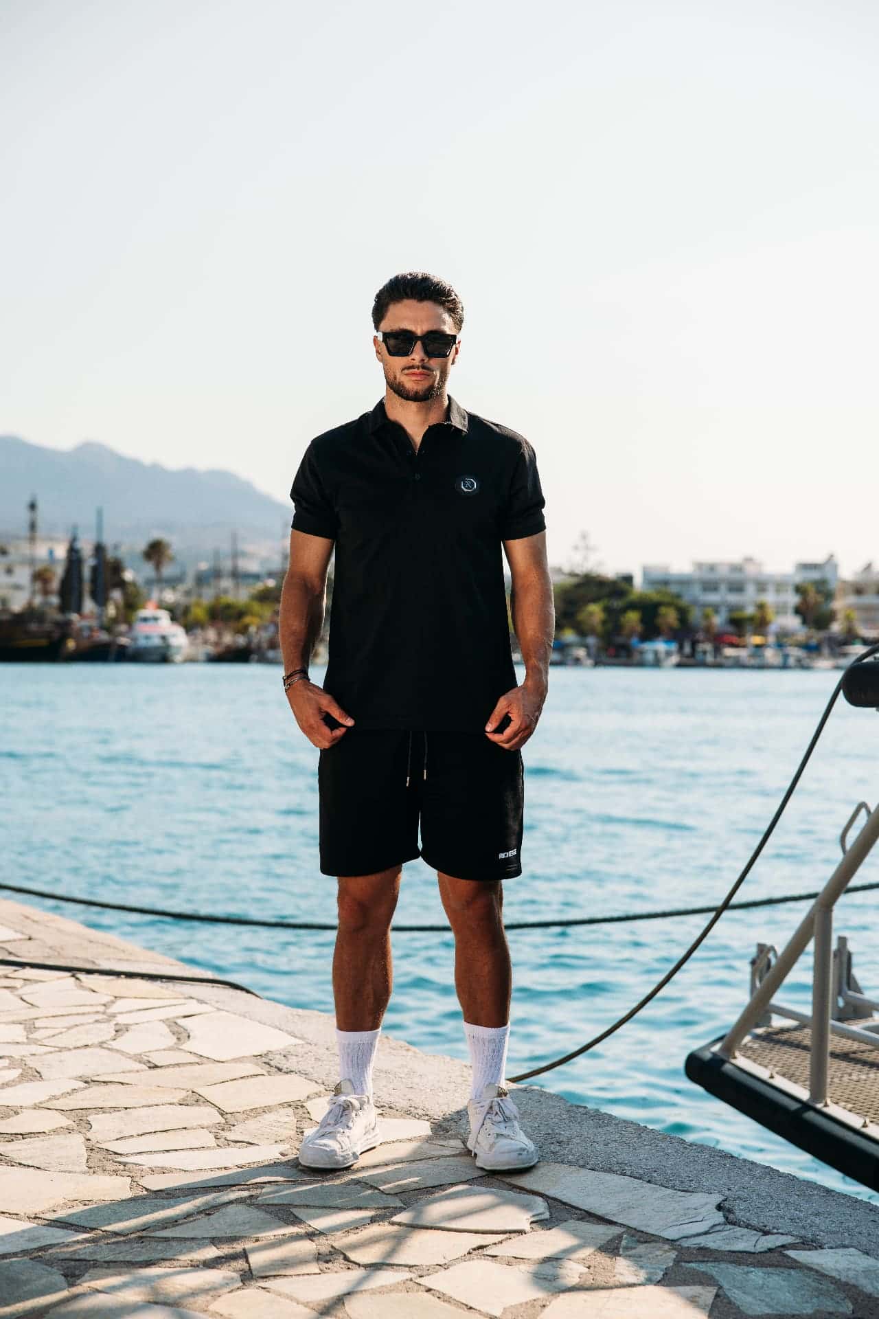 Black polo and shorts set by Richesse