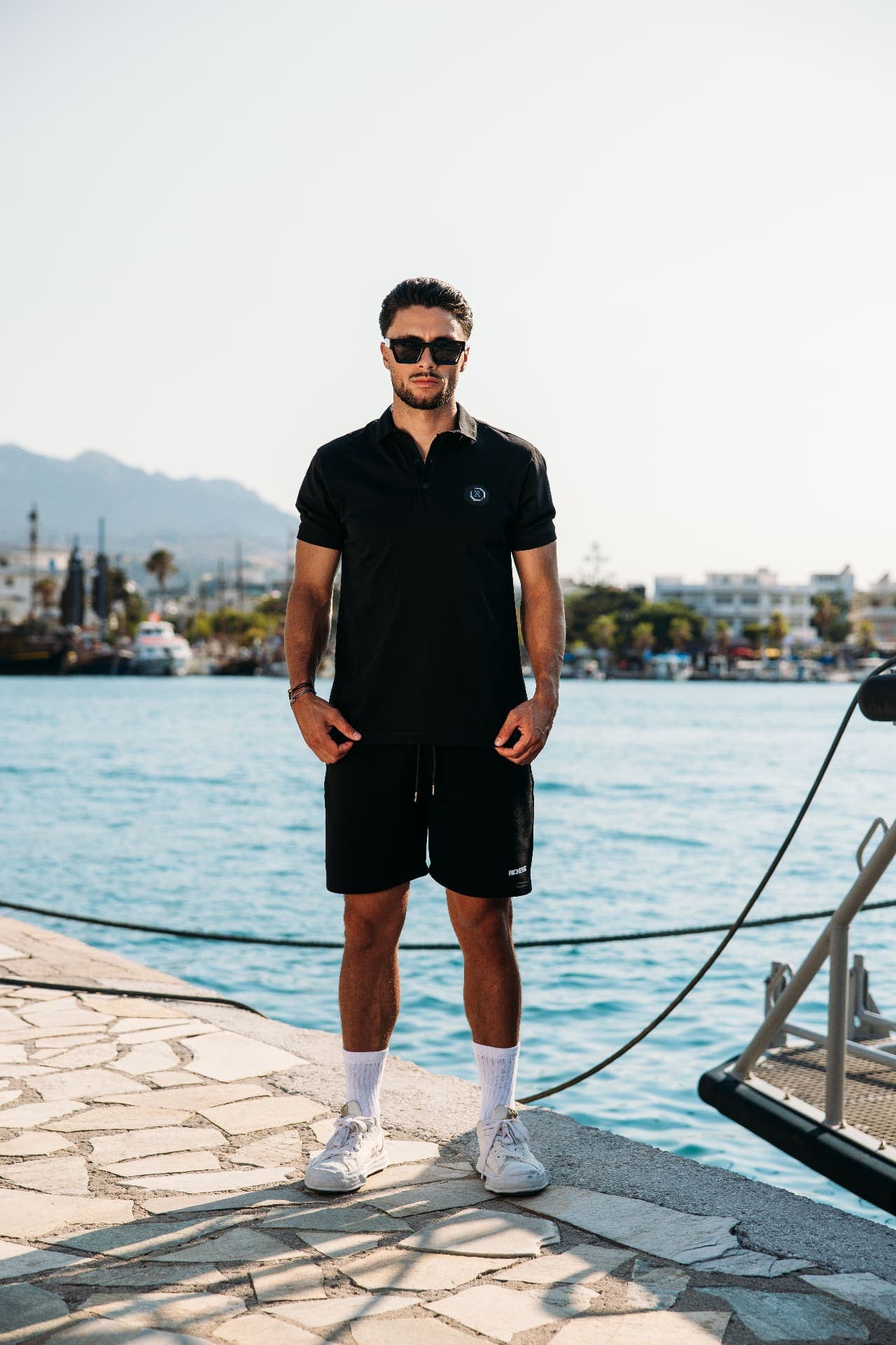 Black polo and shorts set by Richesse